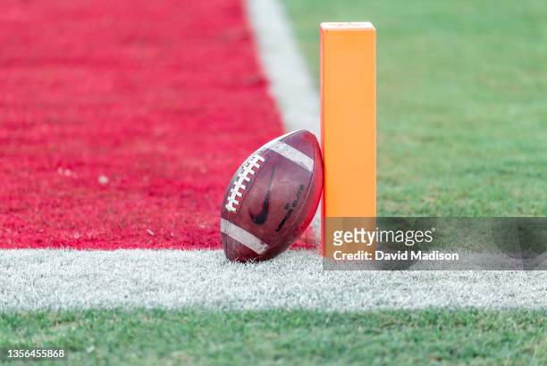 Close up view of an American football leaning on the goal line marker on the field at Stanford Stadium before an NCAA football game between the Notre...
