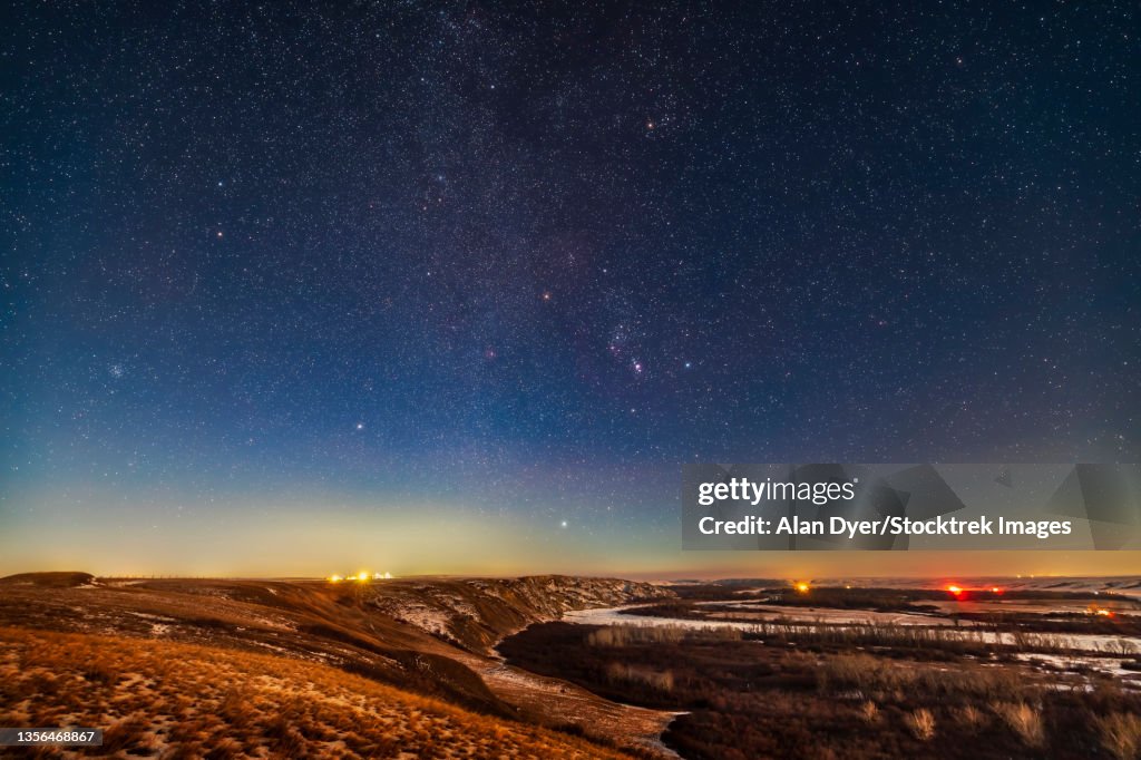 Orion and the winter stars from a viewpoint overlooking the Bow River in Alberta, Canada.