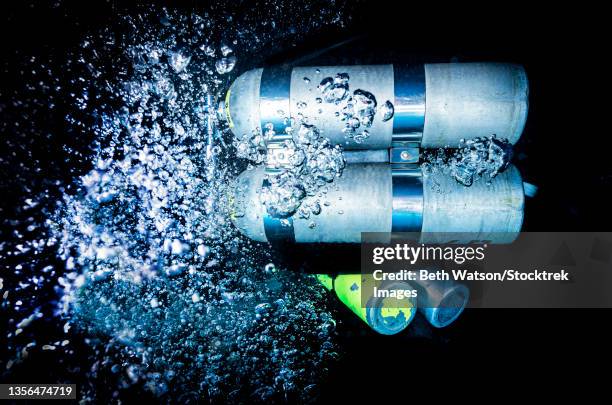 a technical scuba diver descends with bubbles from exhaling. - decompression sickness stock pictures, royalty-free photos & images