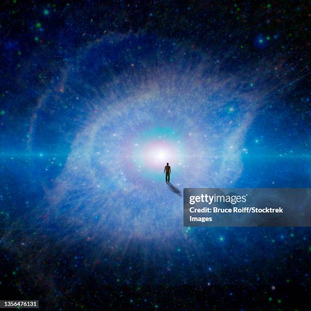 figure of man walking to the center of a galaxy. - supernova stock illustrations