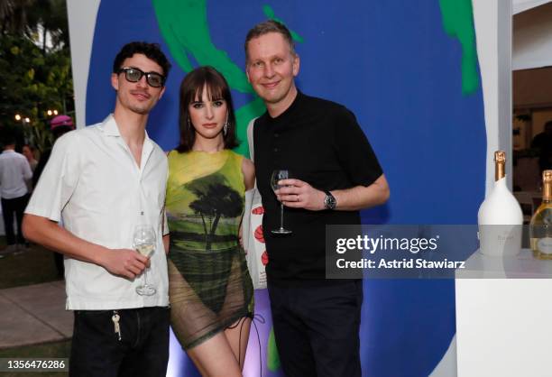 Jacob Bixenman, Hari Nef and David Shrigley attend Unconventional Bubbles with Ruinart + David Shrigley on November 30, 2021 in Miami, Florida.