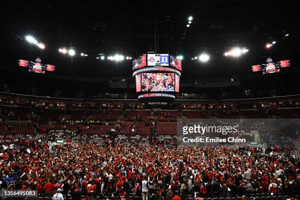 Fans storm the court after the Ohio State Buckeyes upset the Duke Blue Devils 71-66 at Value City Arena on November 30, 2021 in Columbus, Ohio.
