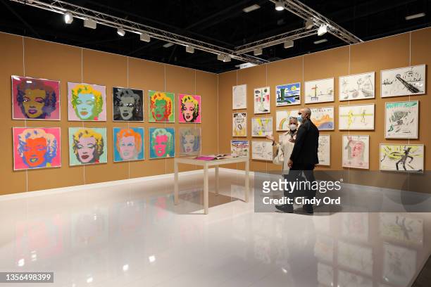 Guests view art on display at the Art Basel Miami Beach VIP Preview 2021 at Miami Beach Convention Center on November 30, 2021 in Miami Beach,...
