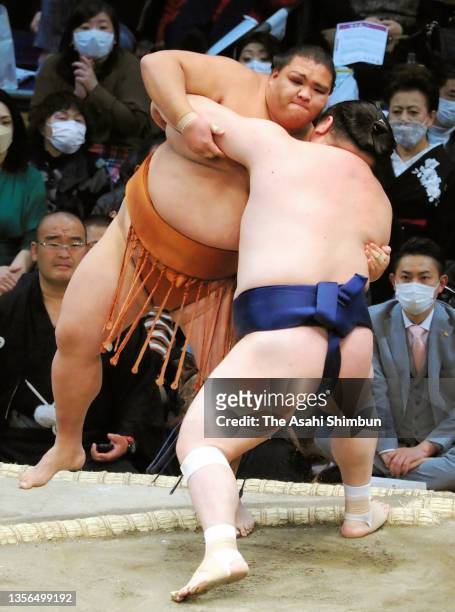 Takarafuji pushes sekiwake Mitakeumi out of the ring to win on day ten of the Grand Sumo Kyushu Tournament at the Fukuoka Convention Center on...