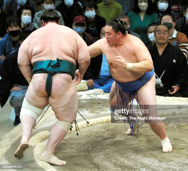 Tamawashi pushes Aoiyama out of the ring to win on day ten of the Grand Sumo Kyushu Tournament at the Fukuoka Convention Center on November 23, 2021...