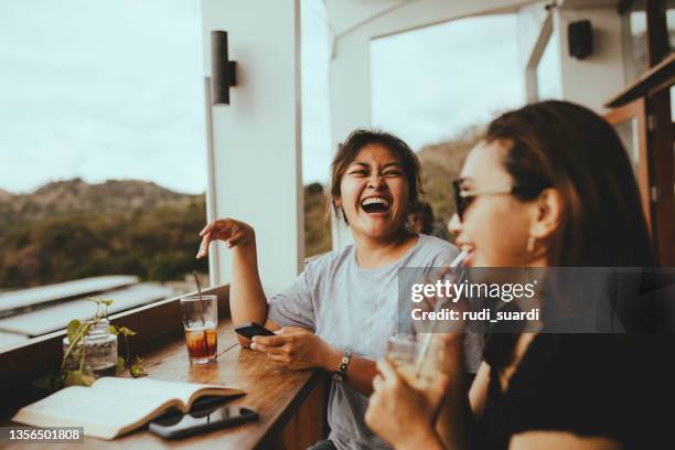 asian woman taking drink and talking in cafe - cola stock pictures, royalty-free photos & images