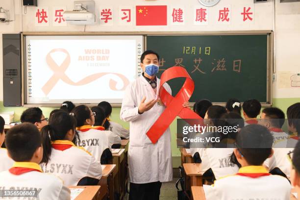 Doctor teaches students about knowledge of the World AIDS Day at Xinle Experimental School on November 30, 2021 in Shijiazhuang, Hebei Province of...