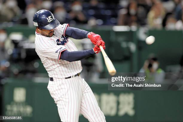 Domingo Santana of the Yakult Swallows hits a solo home run in the 2nd inning during the Japan Series Game Four against Orix Buffaloes at Tokyo Dome...