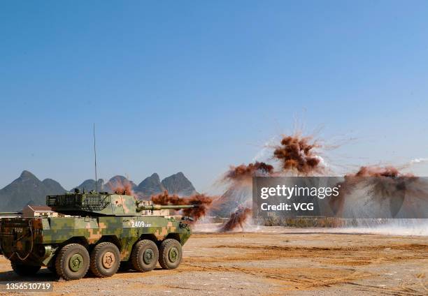 Armored assault vehicles of the People's Liberation Army fire smoke bombs to test new weaponry on November 30, 2021 in Guilin, Guangxi Zhuang...