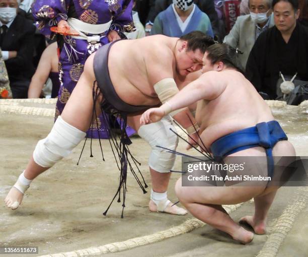 Yokozuna Terunofuji pushes komusubi Ichinojo out of the ring to win on day eleven of the Grand Sumo Kyushu Tournament at the Fukuoka Convention...