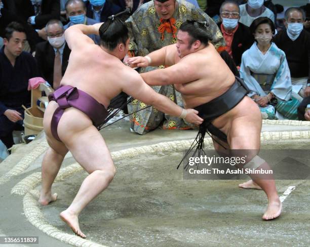 Ozeki Takakeisho pushes Endo out of the ring to win on day eleven of the Grand Sumo Kyushu Tournament at the Fukuoka Convention Center on November...