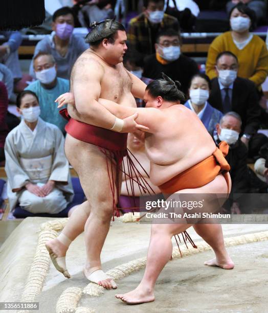 Sekiwake Mitakeumi pushes Takayasu out of the ring to win on day eleven of the Grand Sumo Kyushu Tournament at the Fukuoka Convention Center on...