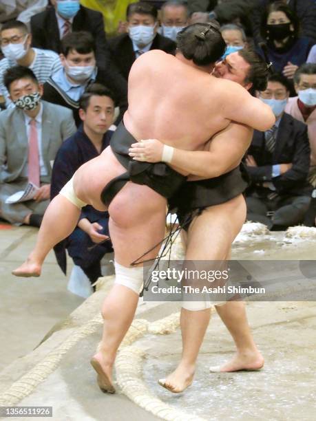 Komusubi Kiribayama pushes Myogiryu out of the ring to win on day eleven of the Grand Sumo Kyushu Tournament at the Fukuoka Convention Center on...