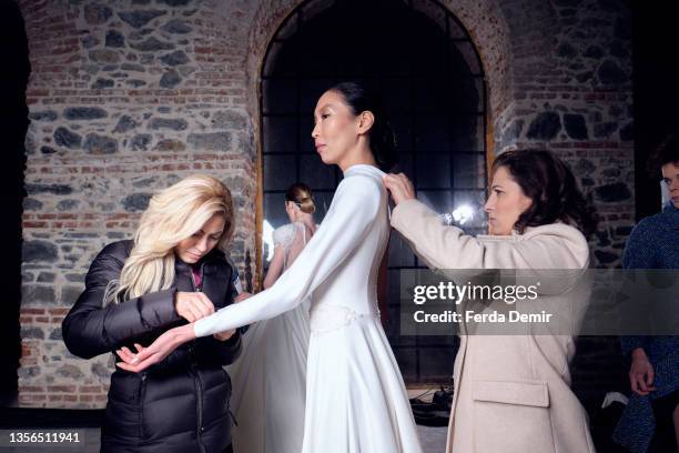 Model gets prepared backstage ahead of the Hakan Akkaya x Cinderella Bridal Capsule Collection at Tersane Istanbul on November 30, 2021 in Istanbul,...