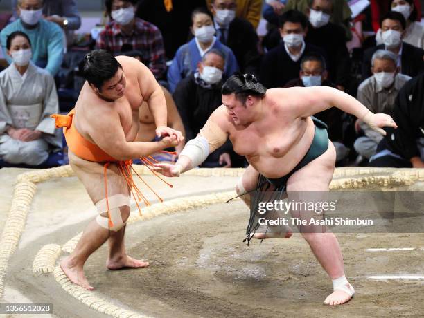 Yutakayama pushes Shimanoumi out of the ring to win on day eleven of the Grand Sumo Kyushu Tournament at the Fukuoka Convention Center on November...