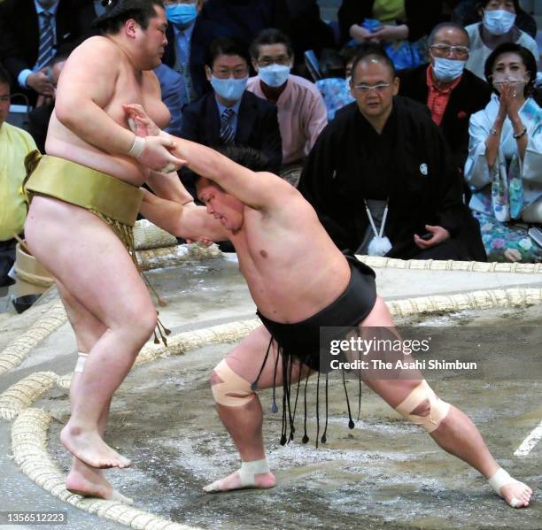 Terutsuyoshi pushes Kagayaki out of the ring to win on day eleven of the Grand Sumo Kyushu Tournament at the Fukuoka Convention Center on November...