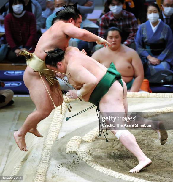 Sadanoumi pushes Ishiura out of the ring to win on day eleven of the Grand Sumo Kyushu Tournament at the Fukuoka Convention Center on November 24,...