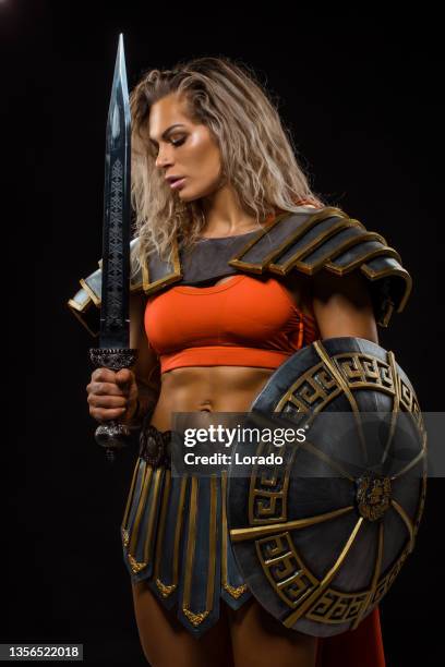 a female warrior gladiator holding a weapon - roman soldier cartoon stock pictures, royalty-free photos & images