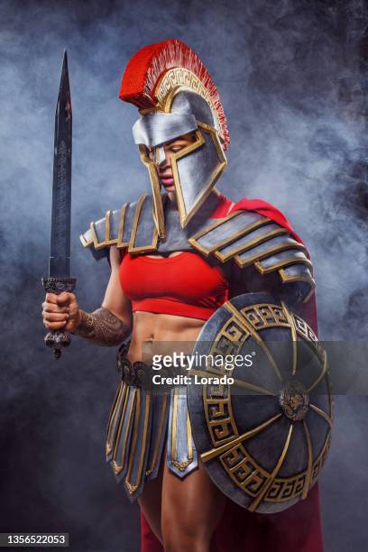 a female warrior gladiator holding a weapon - roman soldier cartoon stock pictures, royalty-free photos & images