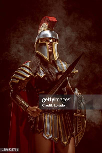 a senior female warrior gladiator holding a weapon - gladiator stock pictures, royalty-free photos & images