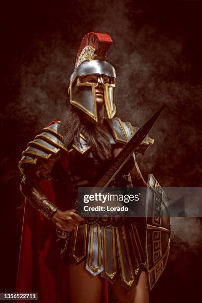 a senior female warrior gladiator holding a weapon - gladiator armour stock pictures, royalty-free photos & images