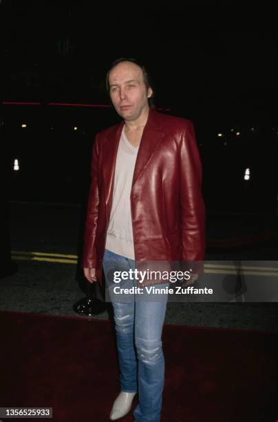 American singer-songwriter and guitarist Dwight Yoakam, wearing a red leather jacket, attends the Westwood premiere of 'All the Pretty Horses' held...