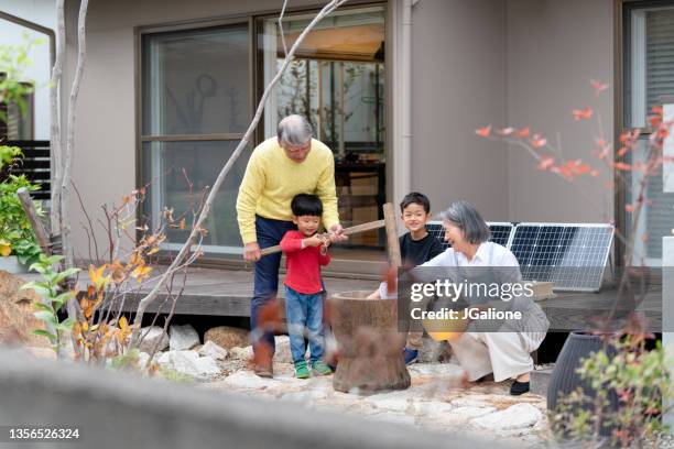 grandparents teaching their grandchildren how to make traditional new years mochi - fuel and power generation bildbanksfoton och bilder