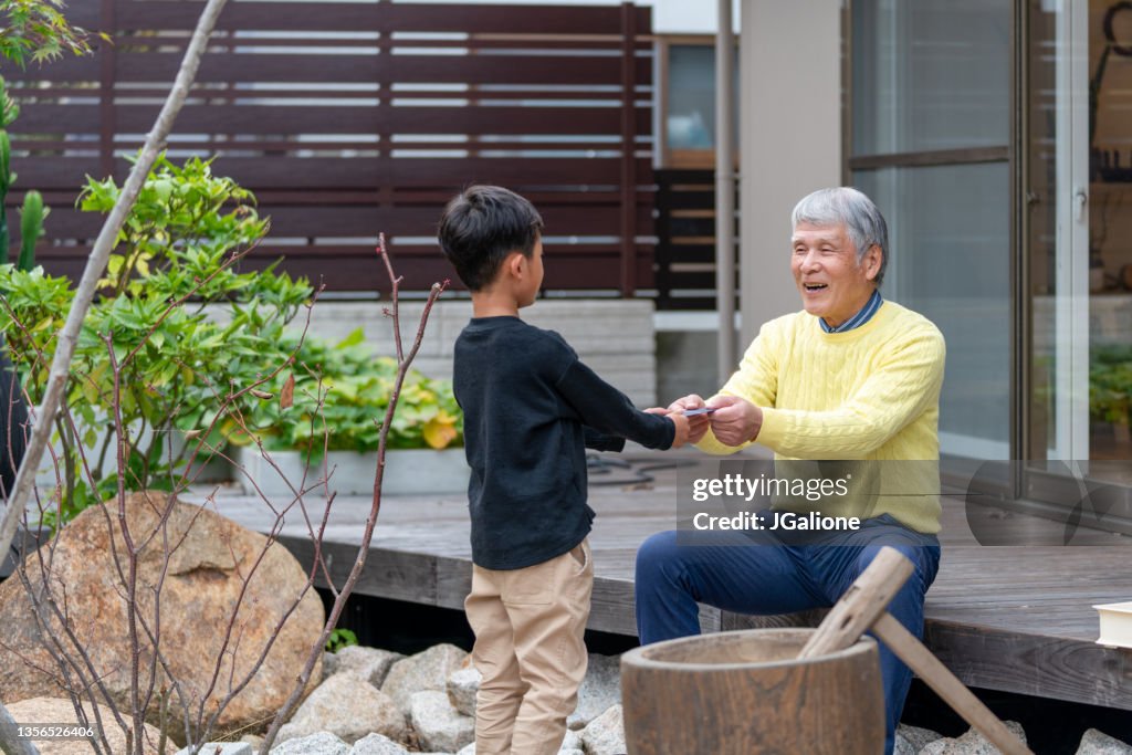 Grandfather giving his grandson otoshidama for New Years