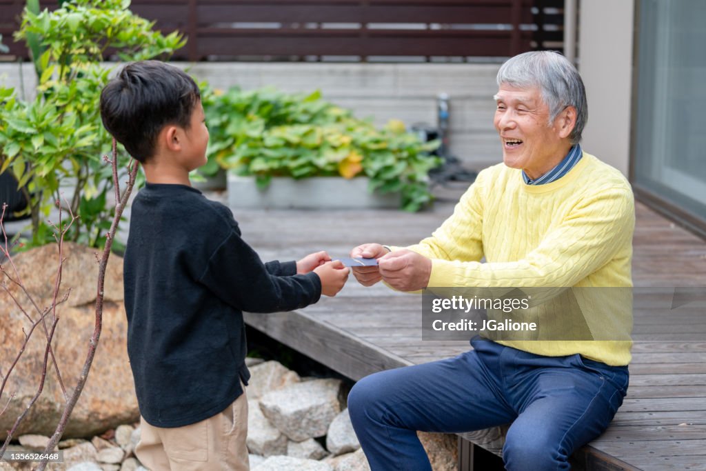 Grandfather giving his grandson otoshidama for New Years