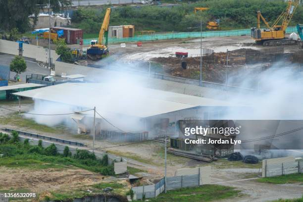 fogging at construction area - fumigation stock-fotos und bilder