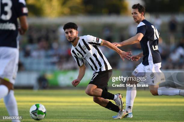 Daniel Bressan of Adelaide City competes with Robbie Kruse of the Victoryduring the FFA Cup round of 32 match between Adelaide City FC and Melbourne...