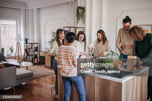 Friends preparing a meal together Friends preparing a meal together