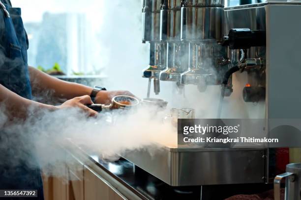 making a cup of hot coffee. - barista foto e immagini stock