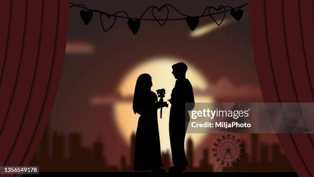 romantic silhouette of loving couple watching sunset - romantic couple back stock illustrations