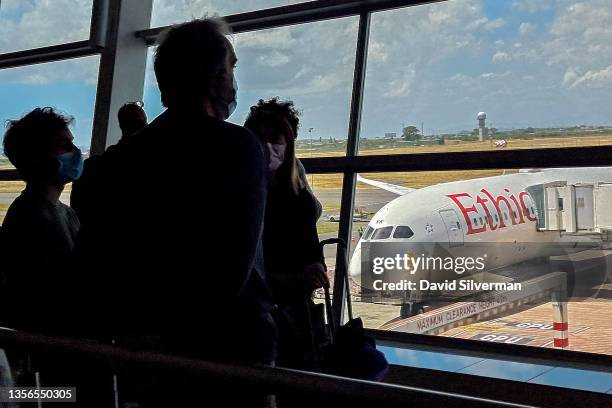 Passengers wait to board Ethiopian Airlines flight ET 846, one of the few international flights leaving the country's second busiest airport after...