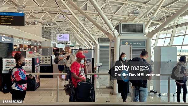 Passengers wait to board Ethiopian Airlines flight ET 846, one of the few international flights leaving the country's second busiest airport after...