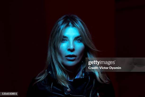 beautiful blonde mature woman in the blue light - motard photos et images de collection