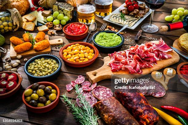 delicious spanish tapas, beer and wine table - kroket stockfoto's en -beelden