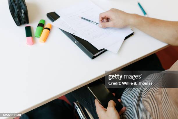 student covertly using smarthone during class - liar stock pictures, royalty-free photos & images