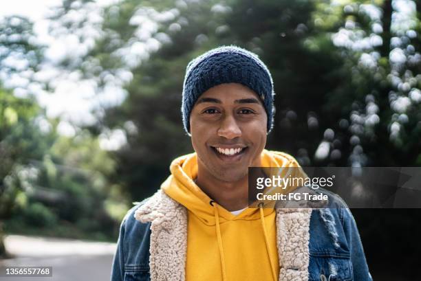 portrait of a young man in a trail - knit hat stock pictures, royalty-free photos & images