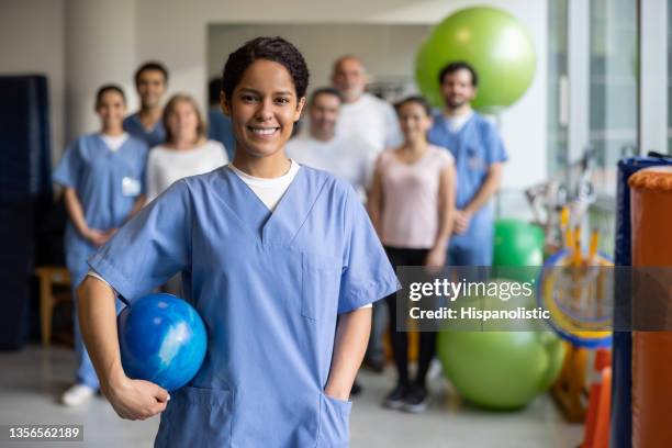 happy physiotherapist working at a rehab center and smiling - happiness therapy stock pictures, royalty-free photos & images