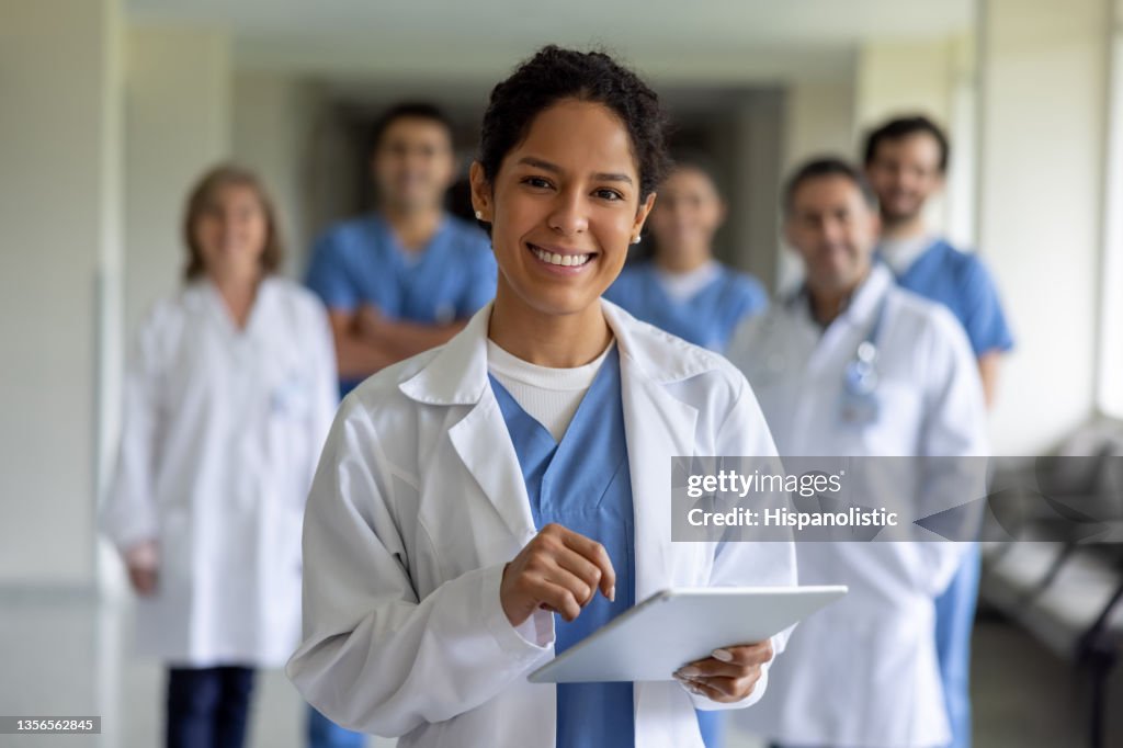 Happy doctor leading a team of healthcare workers at the hospital
