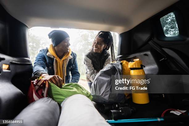 friends getting backpack from car trunk for a hiking - african ethnicity car stock pictures, royalty-free photos & images