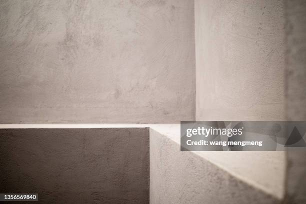 light and shadow in the corner of gray interior concrete building - nicho imagens e fotografias de stock