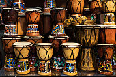 Many small African drums in an oriental souvenir shop.