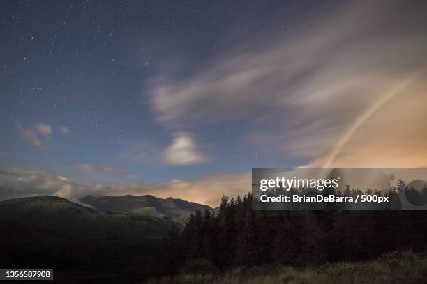 moonbow mountains,scenic view of mountains against sky at night - moonbow stock pictures, royalty-free photos & images