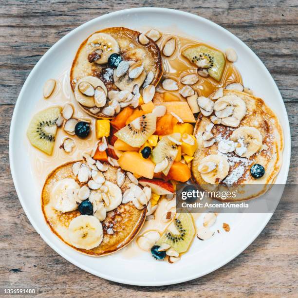 overhead view of lunch on a wooden table - blueberry pancakes bildbanksfoton och bilder