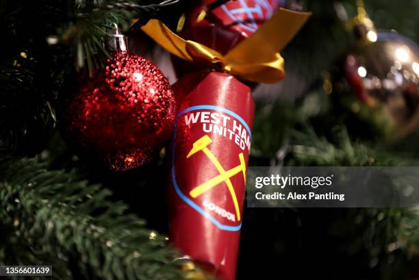 West Ham United branded Christmas crackers are seen on a Christmas tree inside the club shop prior to the Premier League match between West Ham...