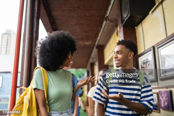 teeange students walking and talking at school - boy and girl talking stock pictures, royalty-free photos & images