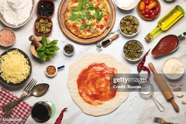 raw dough for pizza with ingredient - chopping block flour stock pictures, royalty-free photos & images